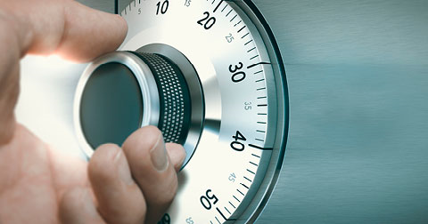 hand turning a dial on a safe to crack a code